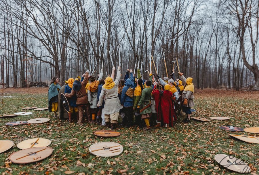Brotherhood huddle with weapons raised