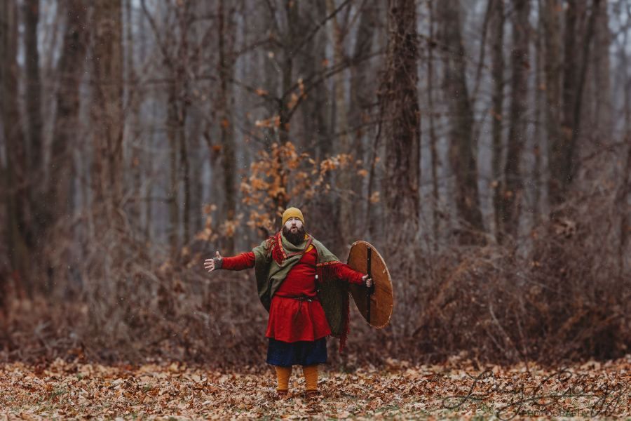 Fighter in red kit with gold hood in winter woods
